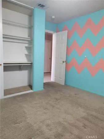a view of an empty room with a kitchen
