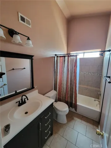 a bathroom with a sink mirror toilet and shower