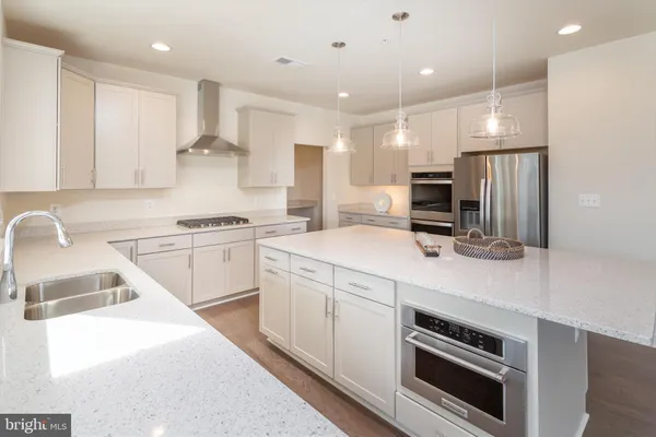 a kitchen with a sink stainless steel appliances and cabinets