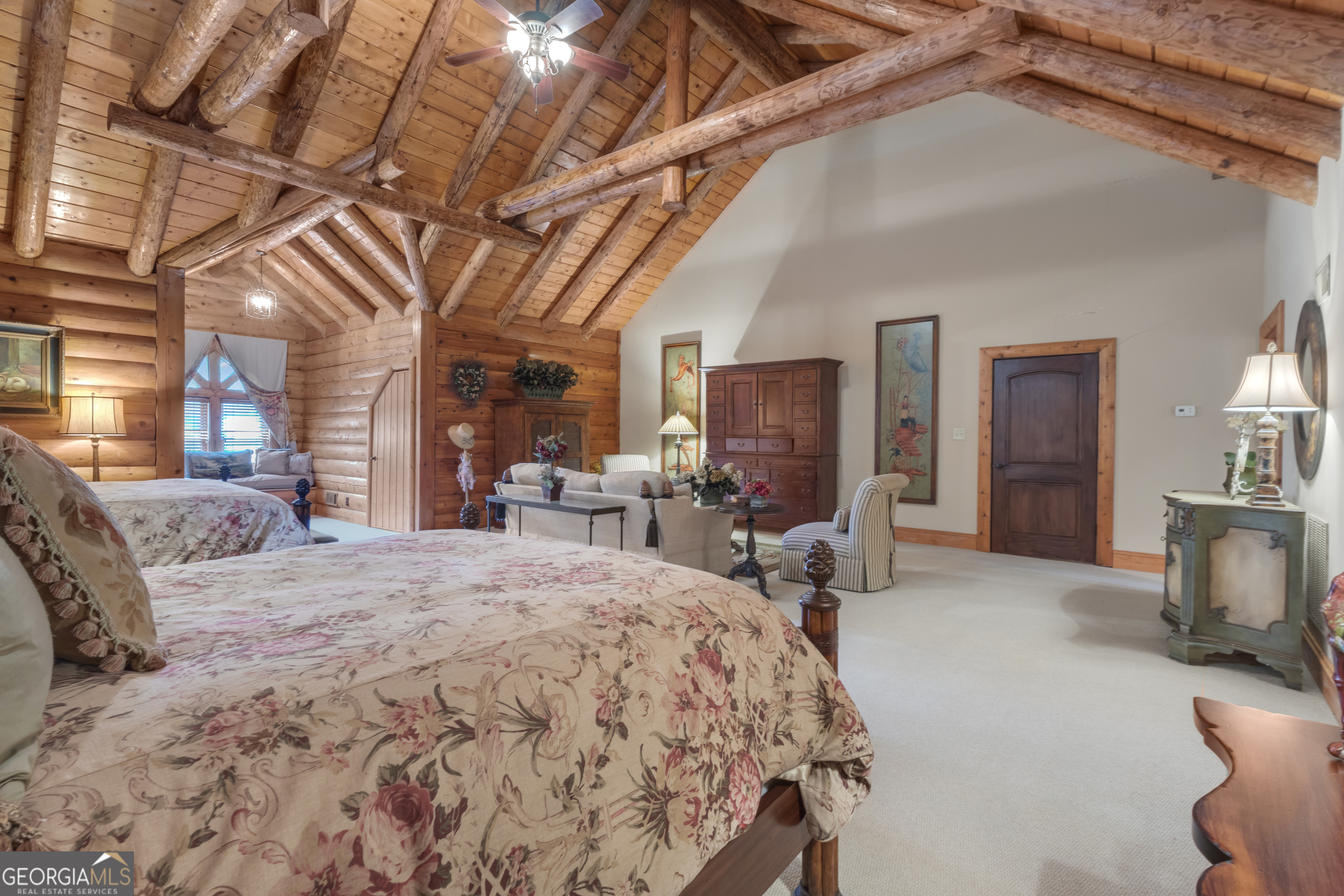 14501 Woolsey Road Hampton, GA 30228 - Photo 45 of 142 a bedroom with a bed a chair and large mirror with the potted plants