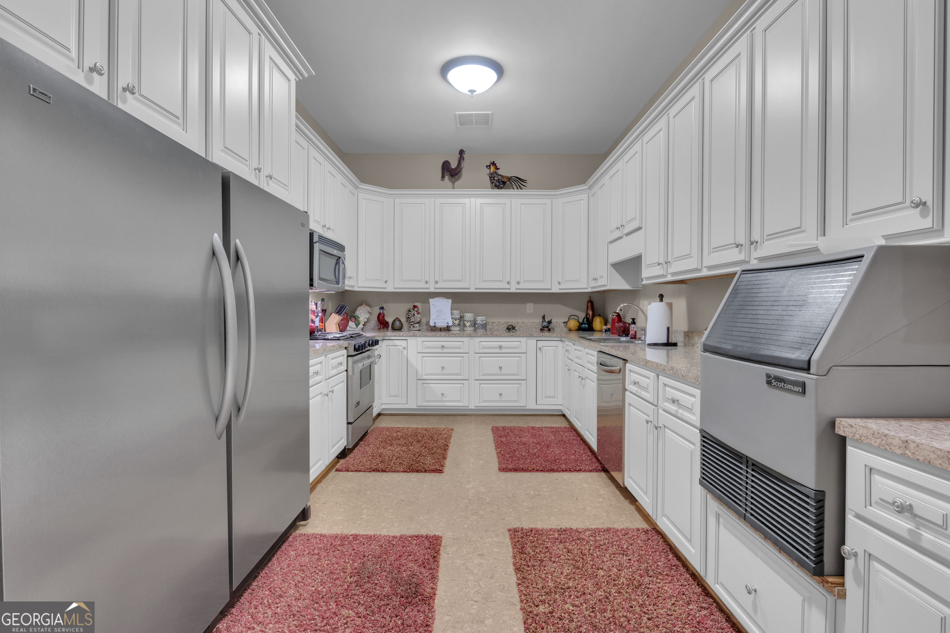 14501 Woolsey Road Hampton, GA 30228 - Photo 89 of 142 a kitchen with cabinets and stainless steel appliances