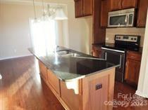 5204 Prosperity Church Road Charlotte, NC 28269 - Photo 2 of 8 a kitchen with stainless steel appliances granite countertop a sink and a stove
