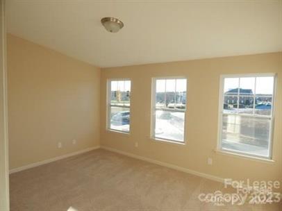 5204 Prosperity Church Road Charlotte, NC 28269 - Photo 6 of 8 an empty room with windows