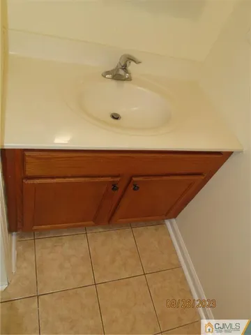 a kitchen with a refrigerator sink and cabinets