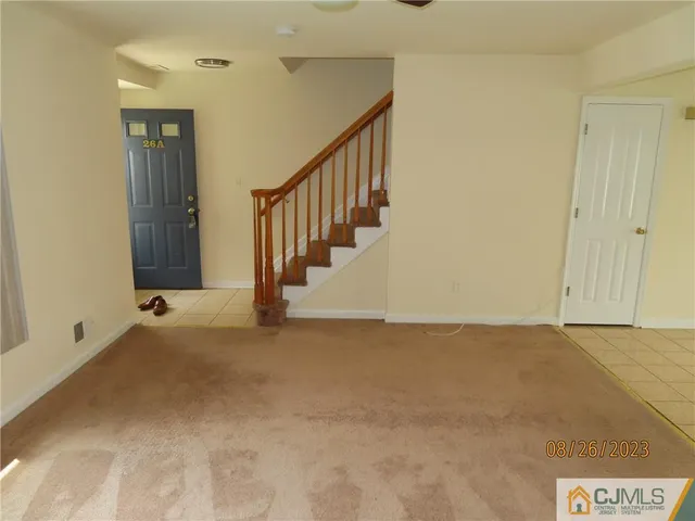 a view of an empty room with stairs