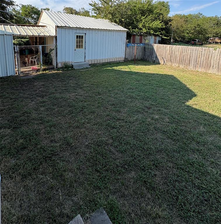 407 North Lane Street Decatur, TX 76234 - Photo 17 of 19 a view of a backyard with a small cabin