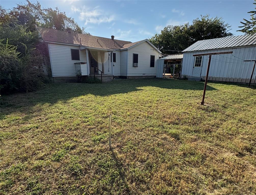 407 North Lane Street Decatur, TX 76234 - Photo 18 of 19 a view of a house with a yard and a tree