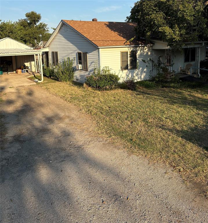 407 North Lane Street Decatur, TX 76234 - Photo 4 of 19 a front view of a house with a yard and garage