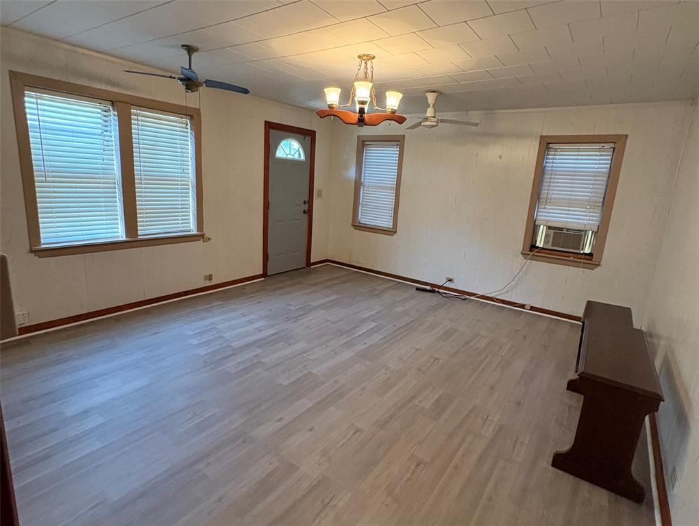 407 North Lane Street Decatur, TX 76234 - Photo 6 of 19 wooden floor in an empty room with a window