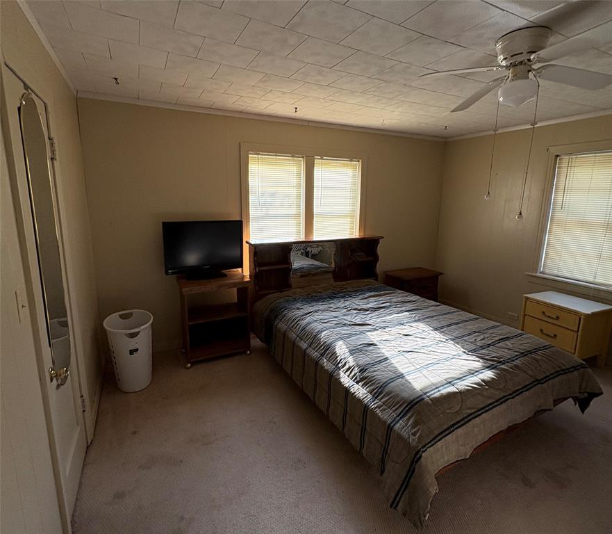 407 North Lane Street Decatur, TX 76234 - Photo 9 of 19 a bedroom with a bed and a television