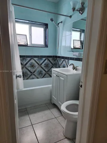 a bathroom with a sink a toilet and bathtub