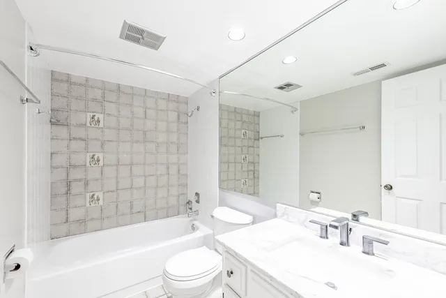 a bathroom with a sink a toilet and bathtub