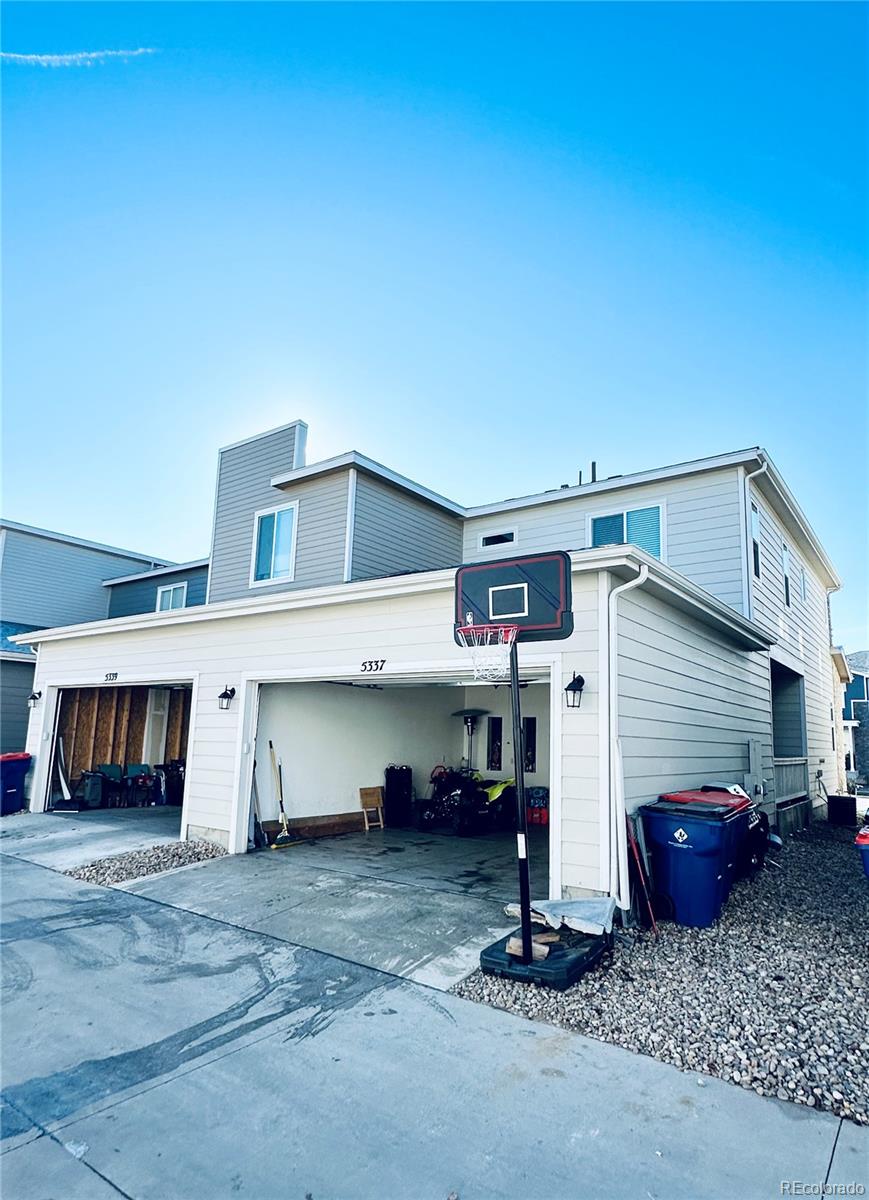 5337 Warrior Street Frederick, CO 80504 - Photo 17 of 17 a view of a house with a barbeque and wooden stairs