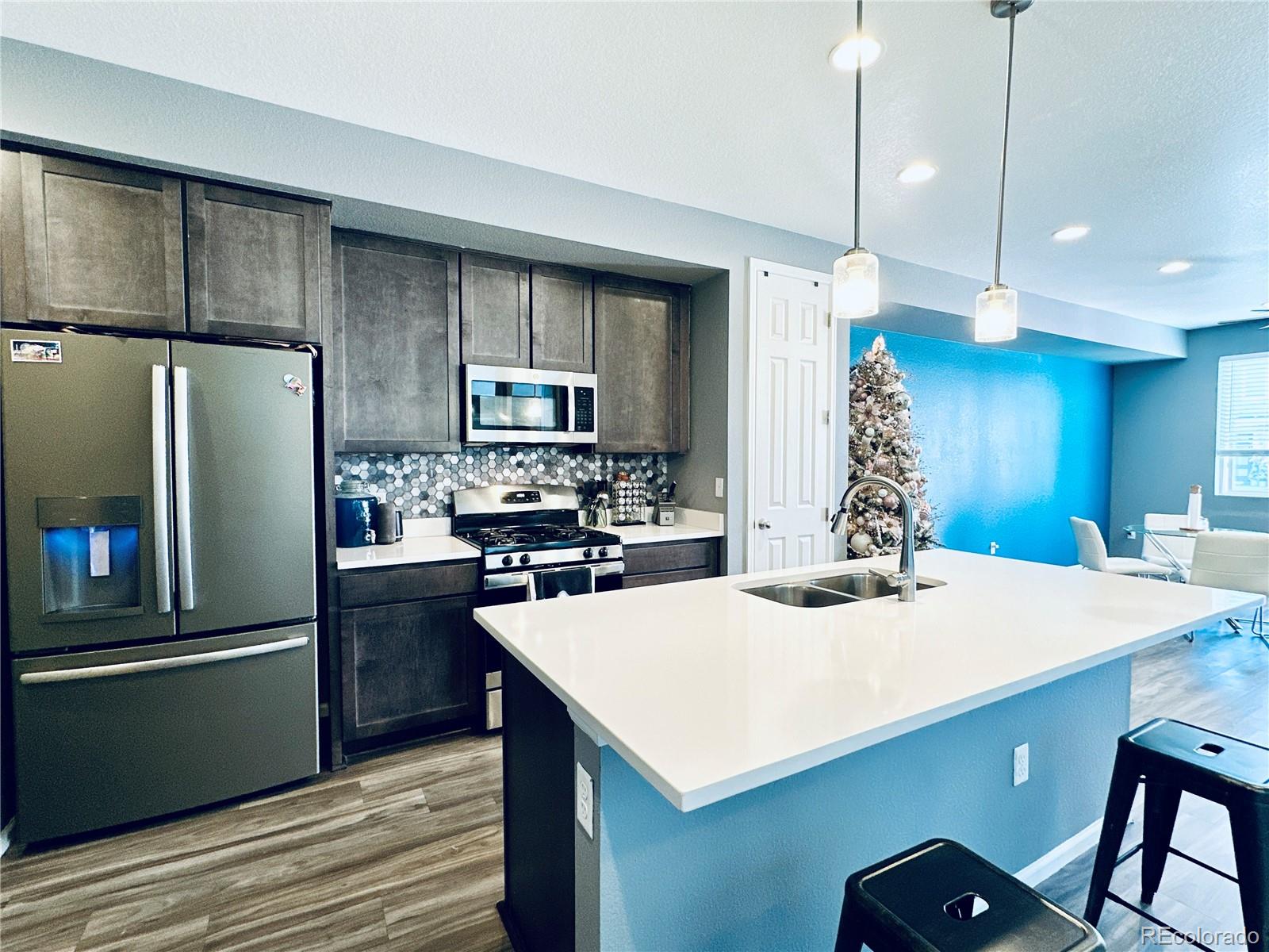 5337 Warrior Street Frederick, CO 80504 - Photo 4 of 17 a kitchen with kitchen island a sink appliances and cabinets