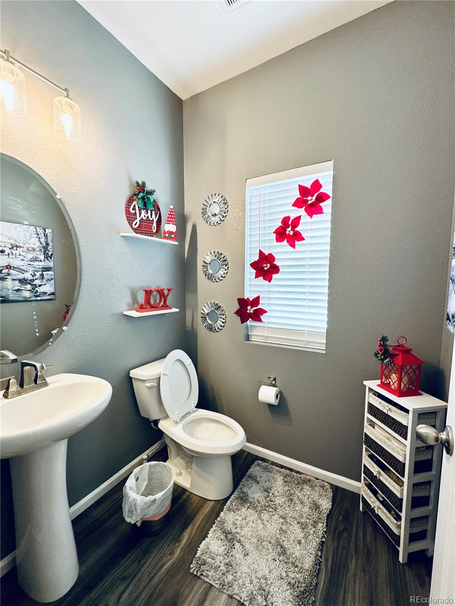5337 Warrior Street Frederick, CO 80504 - Photo 6 of 17 a bathroom with a sink mirror vanity and toilet