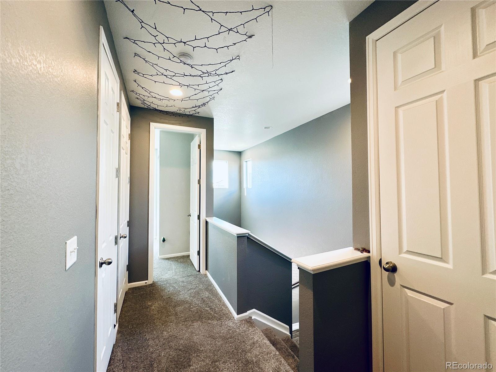 5337 Warrior Street Frederick, CO 80504 - Photo 8 of 17 view of a hallway with wooden cabinets