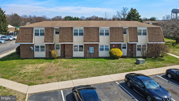 a view of a house with a yard and a garden