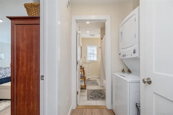 a view of a hallway with a livingroom and a bathroom