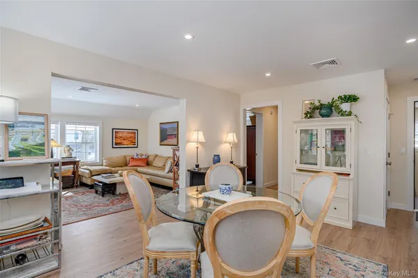 a living room with furniture a flat screen tv and large window