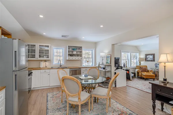 a dining room with furniture and wooden floor