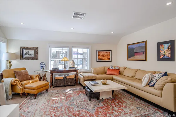 a living room with furniture wooden floor and a table