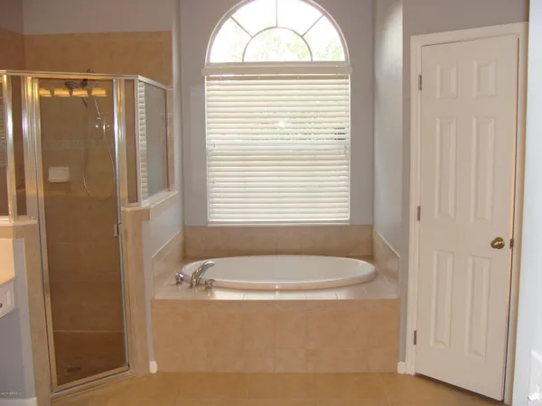 a bathroom with a tub and a window