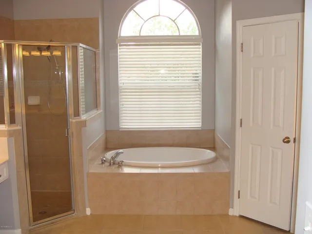 a bathroom with a tub and a window