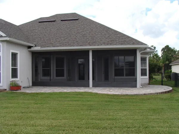 a front view of a house with a garden and yard