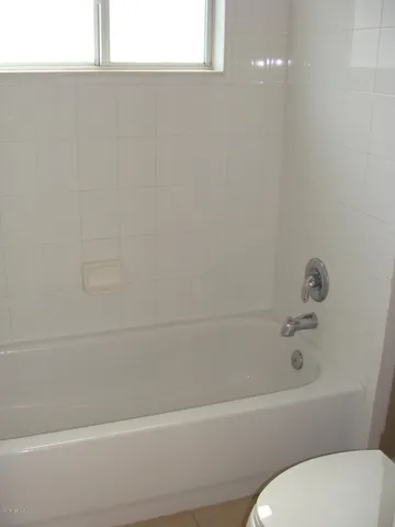 a bathroom with a toilet and bathtub