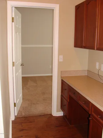 a kitchen with a sink a refrigerator and cabinets
