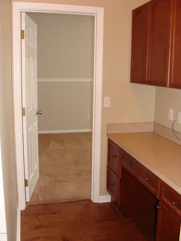 a kitchen with a sink a refrigerator and cabinets