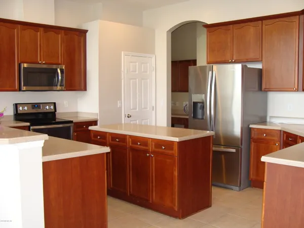 a kitchen with stainless steel appliances a refrigerator stove and microwave