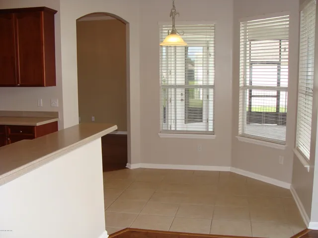 a kitchen with windows and cabinet