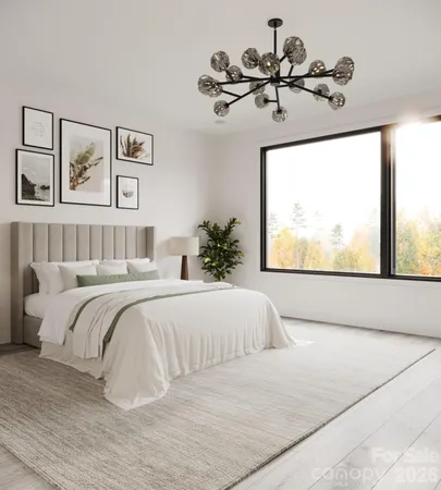a bedroom with a large bed and a chandelier