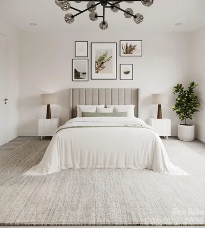a bedroom with a large bed and a painting on the wall