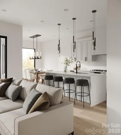 a living room with furniture a large window and a wooden floor