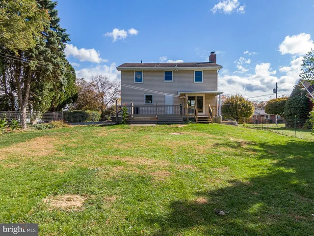 a view of a house with a swimming pool and a big yard
