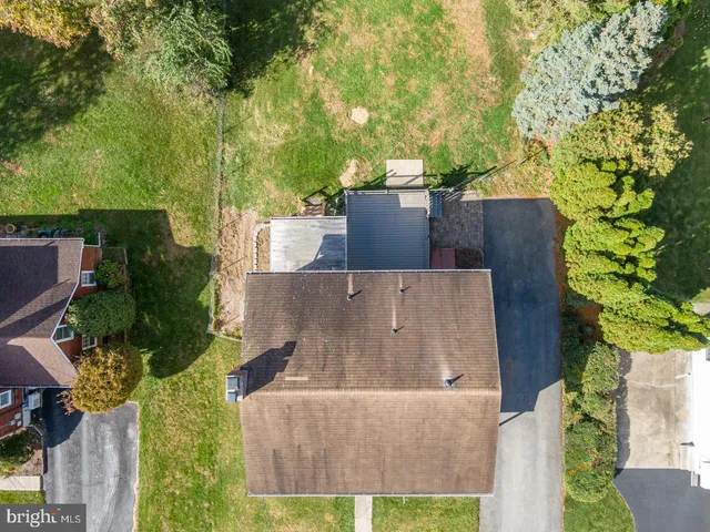 an aerial view of a house with a yard