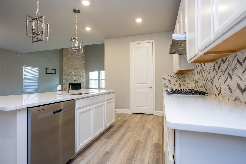 2436 Yosemite Way Corinth, TX 76210 - Photo 11 of 40 a view of a kitchen with a sink and wooden floor