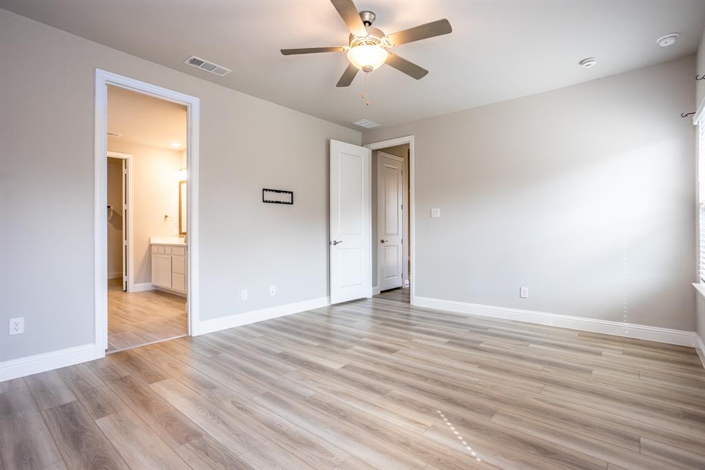 2436 Yosemite Way Corinth, TX 76210 - Photo 22 of 40 a view of empty room with wooden floor