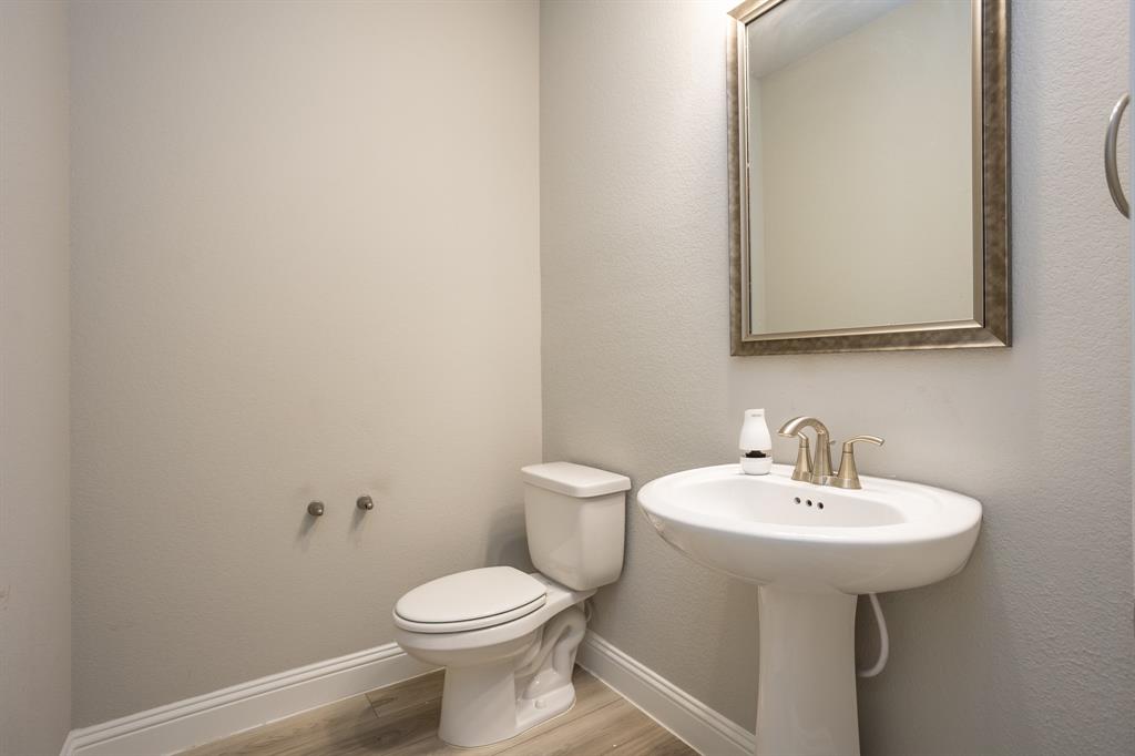 2436 Yosemite Way Corinth, TX 76210 - Photo 6 of 40 a bathroom with a sink a toilet and mirror