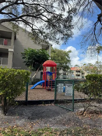 a view of a park with iron fence