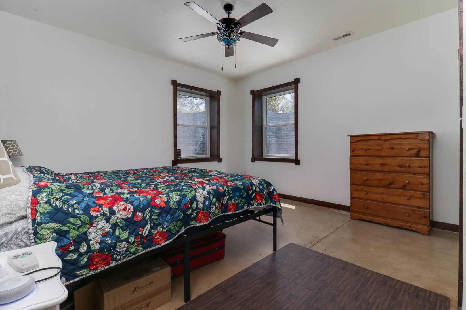 12014 Prairie Center Road Clinton, IL 61727 - Photo 24 of 56 a bed room with a bed mirror and a ceiling fan