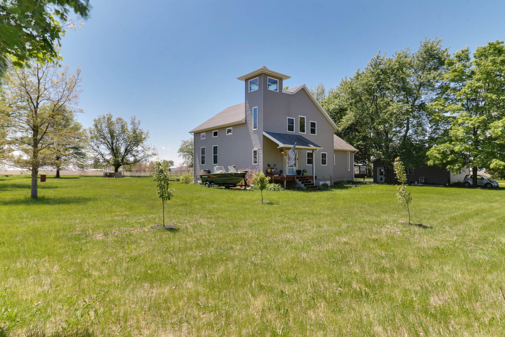 12014 Prairie Center Road Clinton, IL 61727 - Photo 40 of 56 a front view of house with yard and trees in the background