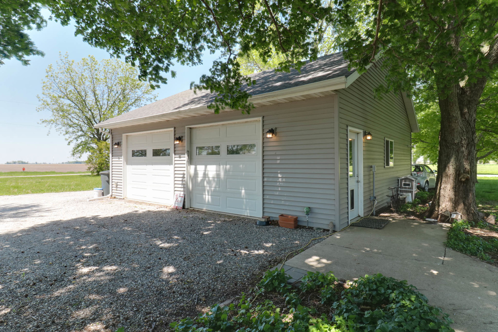 12014 Prairie Center Road Clinton, IL 61727 - Photo 41 of 56 a view of a small yard in front of a house with large tree