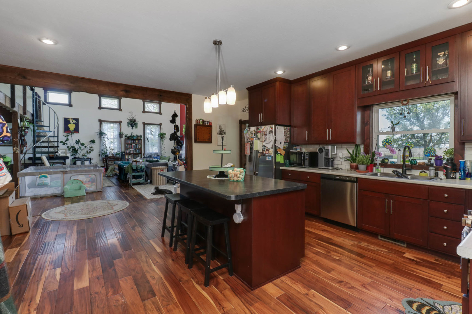 12014 Prairie Center Road Clinton, IL 61727 - Photo 10 of 56 a kitchen with stainless steel appliances granite countertop a stove a refrigerator a sink dishwasher with wooden cabinets and wooden floor