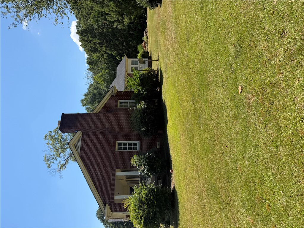 715 Concord Road Anderson, SC 29621 - Photo 3 of 24 A classic brick exterior, framed by a sprawling green lawn, welcomes you to this charming home.