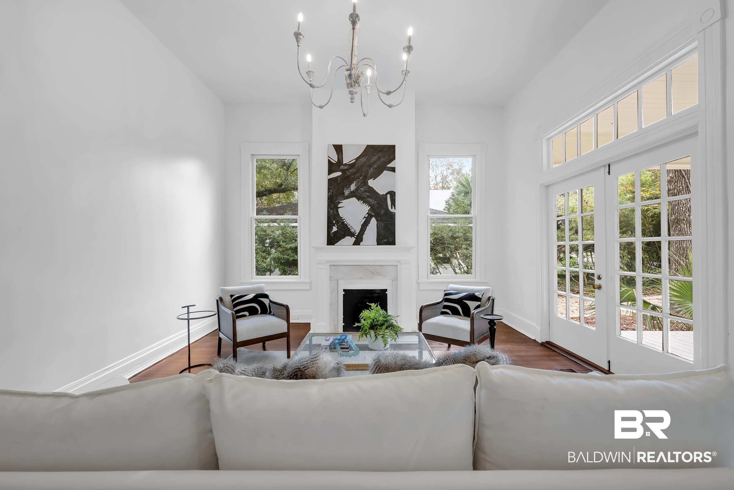 1662 Government Street Mobile, AL 36604 - Photo 6 of 33 Living room featuring wood finished floors, a chandelier, and a fireplace