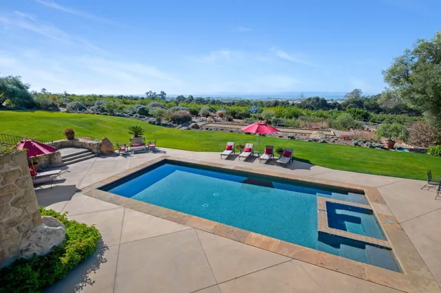 a bedroom with a bed a table and chair