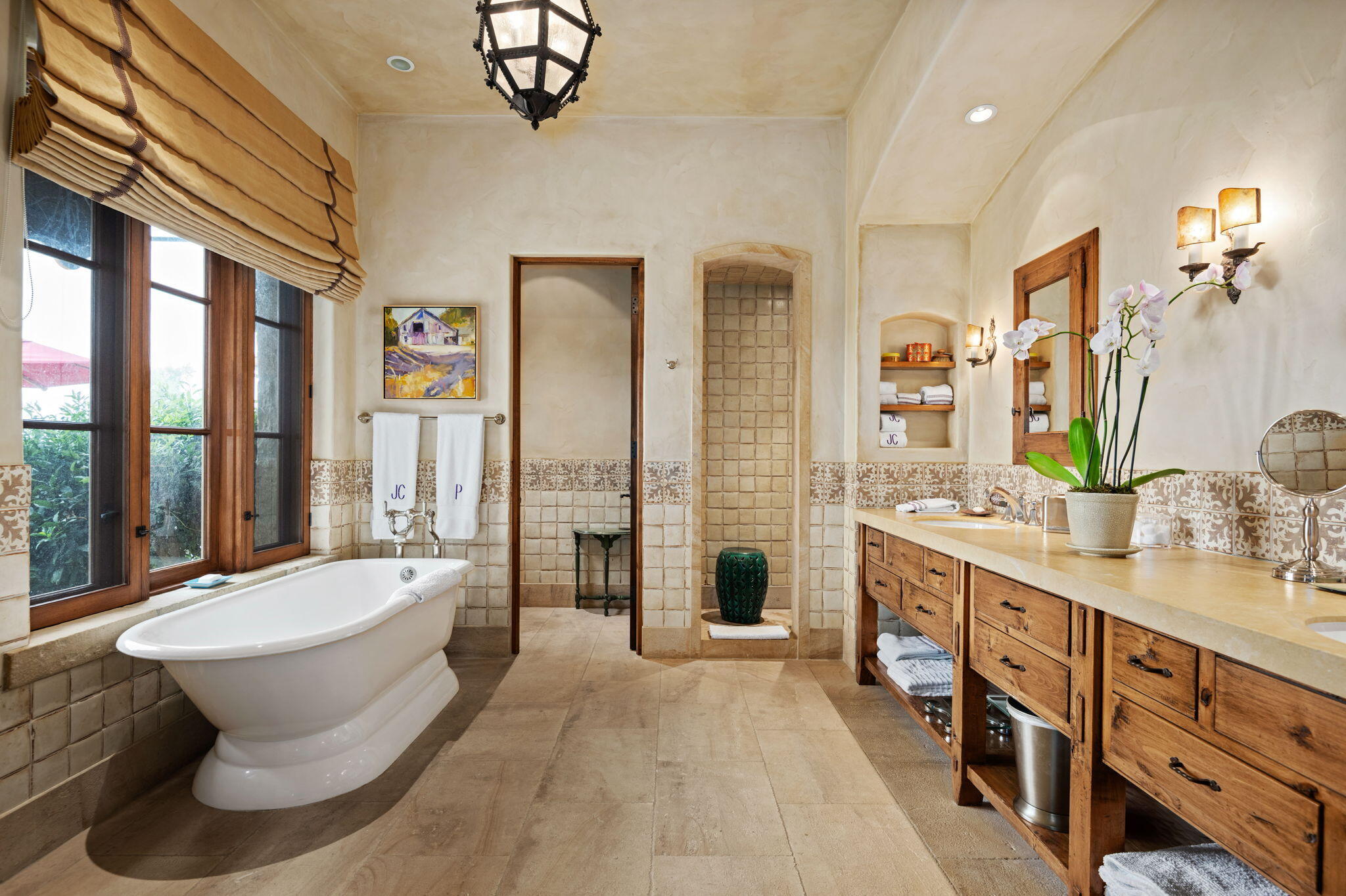 1915 Monte Allegro Drive Carpinteria, CA 93013 - Photo 21 of 59 a spacious bathroom with a double vanity sink a mirror a bathtub and next to a window